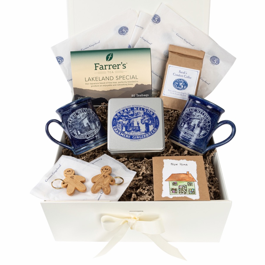 A cream gift hamper filled with Grasmere Gingerbread, mugs, tea and conserves