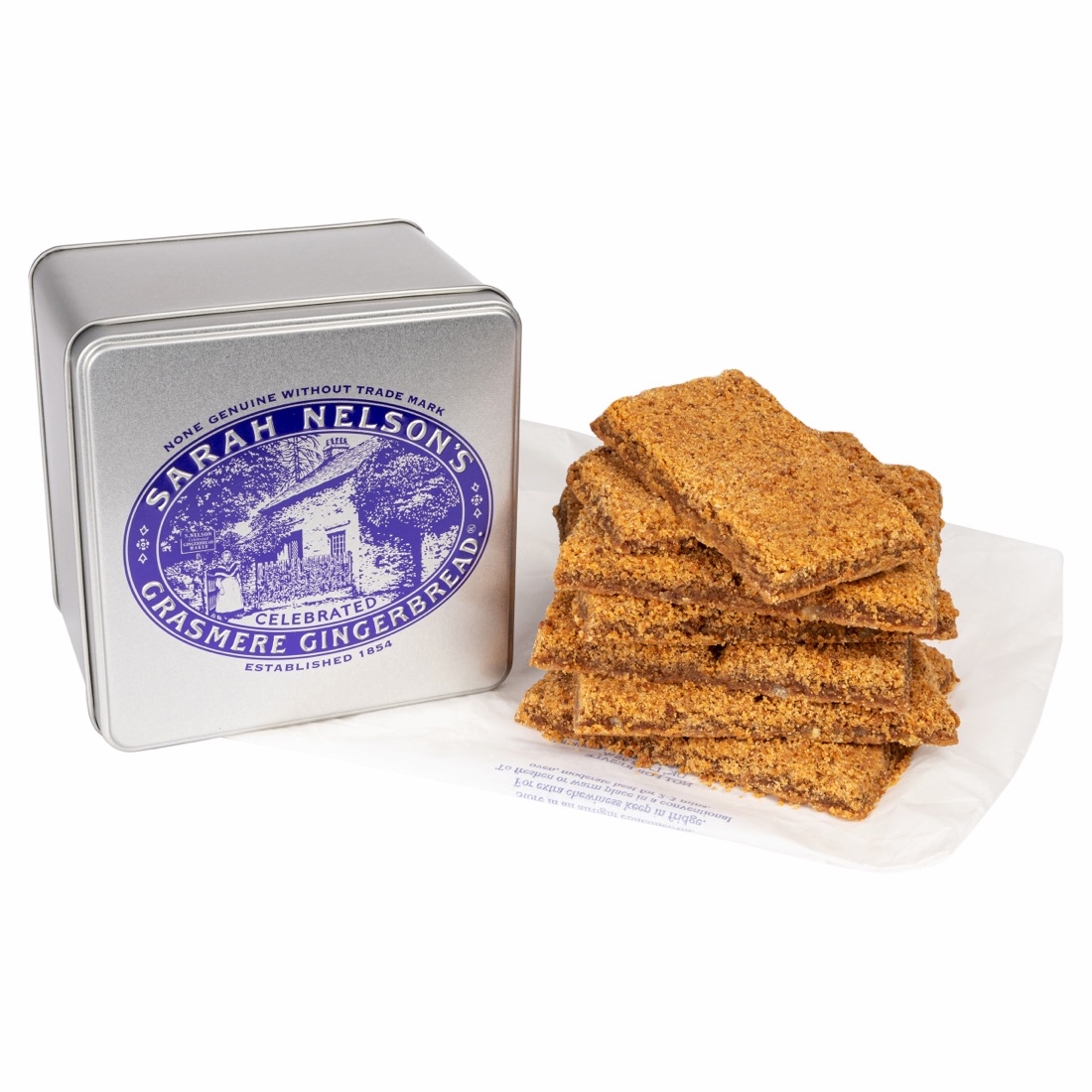 A tin of Sarah Nelson's Grasmere Gingerbread beside a stack of freshly baked gingerbread